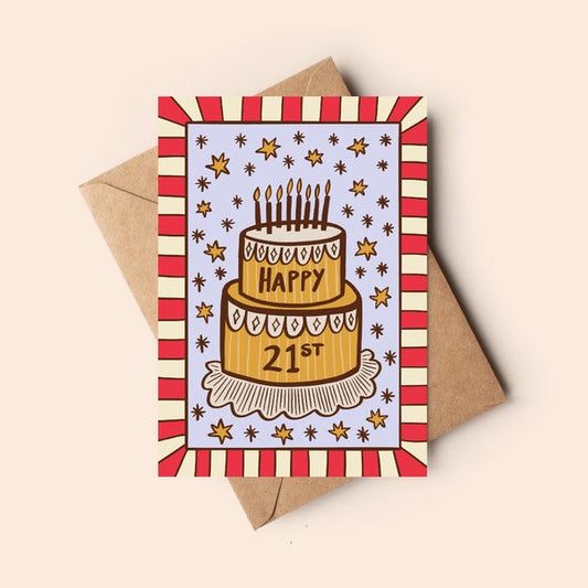 Birthday card with cake illustration and 'Happy 21st' text on a striped border, with a brown envelope.