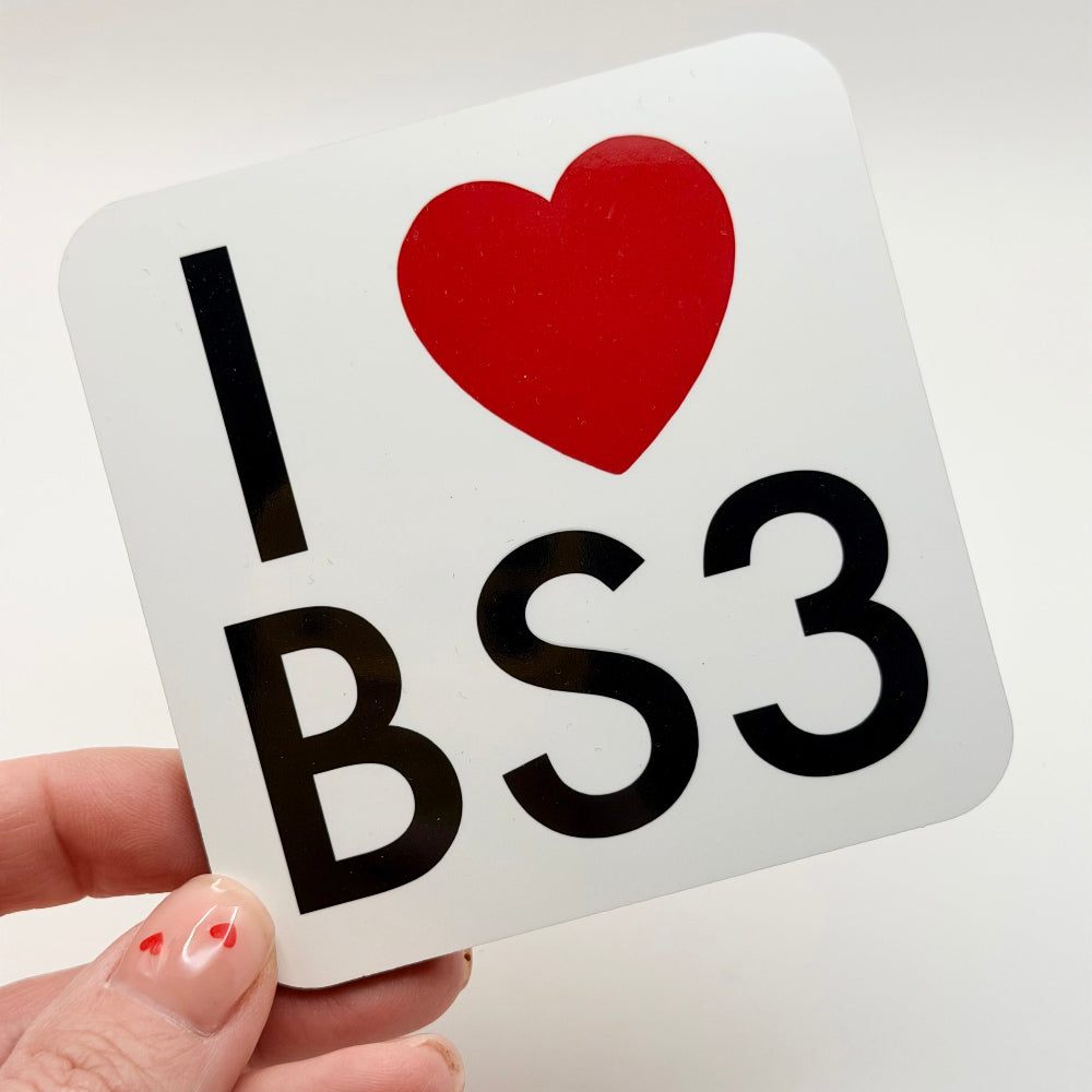 Sticker with 'I ❤️ BS3' text held by a hand on a light background