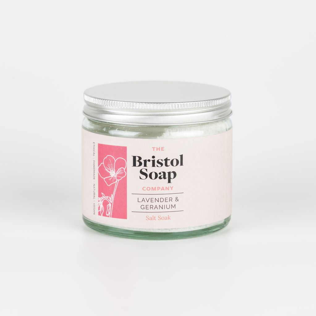Jar of salt soak from The Bristol Soap Company with a pink label on a white background