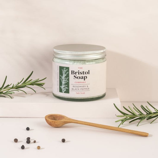 Bristol salt soak jar with rosemary sprigs and a wooden spoon on a light background