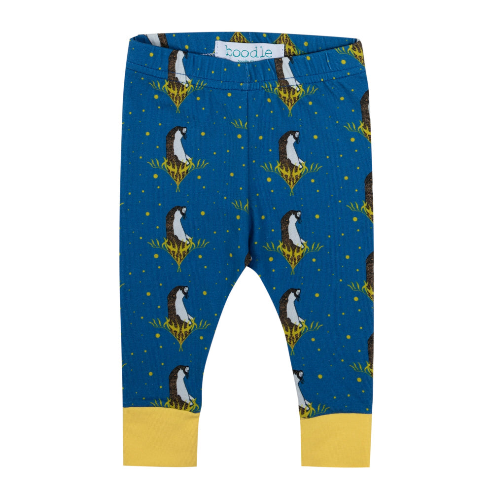 Blue leggings with a penguin print and yellow cuff, shown flat on a white background. The brand name 'boodie' is visible on the inner waistband label.